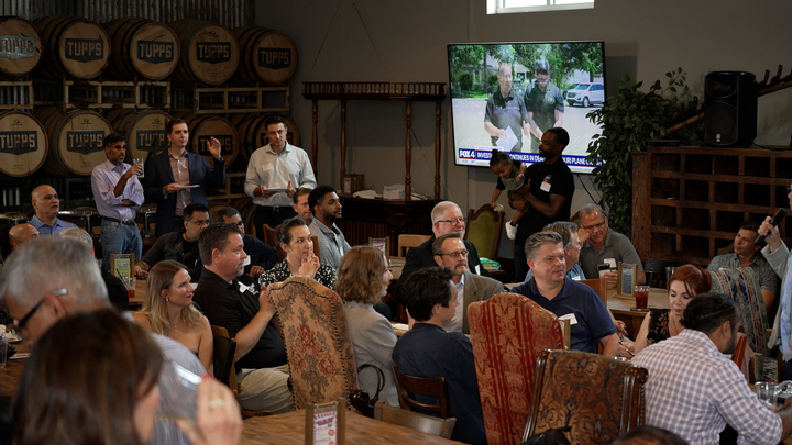 Builders at a table during open networking