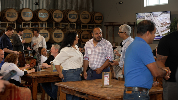 Small group networking by the barrel wall